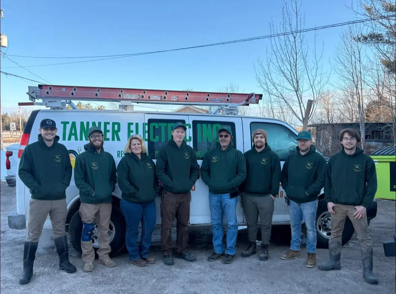 The Tanner Electric Inc. team standing in front of a white Tanner Electric Inc. work van.