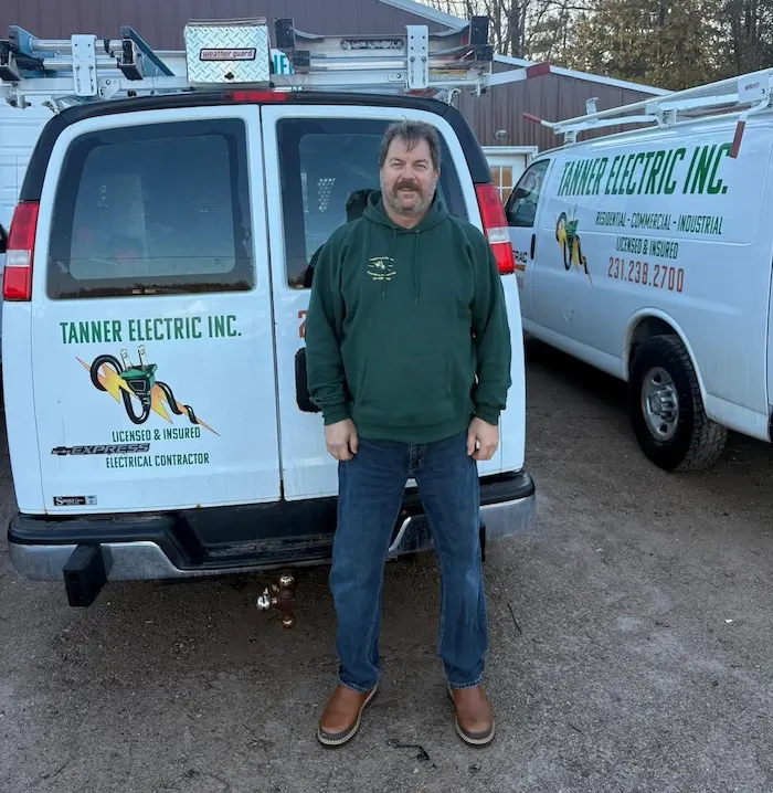 Bill Dingman, a member of the Tanner Electric Inc. team, wearing a Tanner Electric Inc. shirt and smiling.