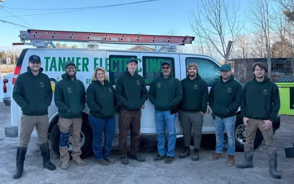 The Tanner Electric Inc. team of licensed electricians, authorized Generac Technicians, and electrical apprentices standing in front of a Tanner Electric inc. workvan.